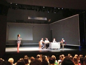 Bebe Miller brings two audience members up on stage to help demonstrate a section of the work.